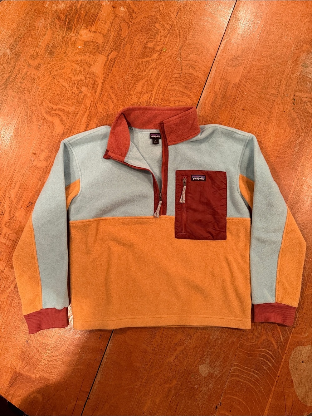 Patagonia Kids' Microdini 1/2-Zip Pullover in the colorway Dried Mango